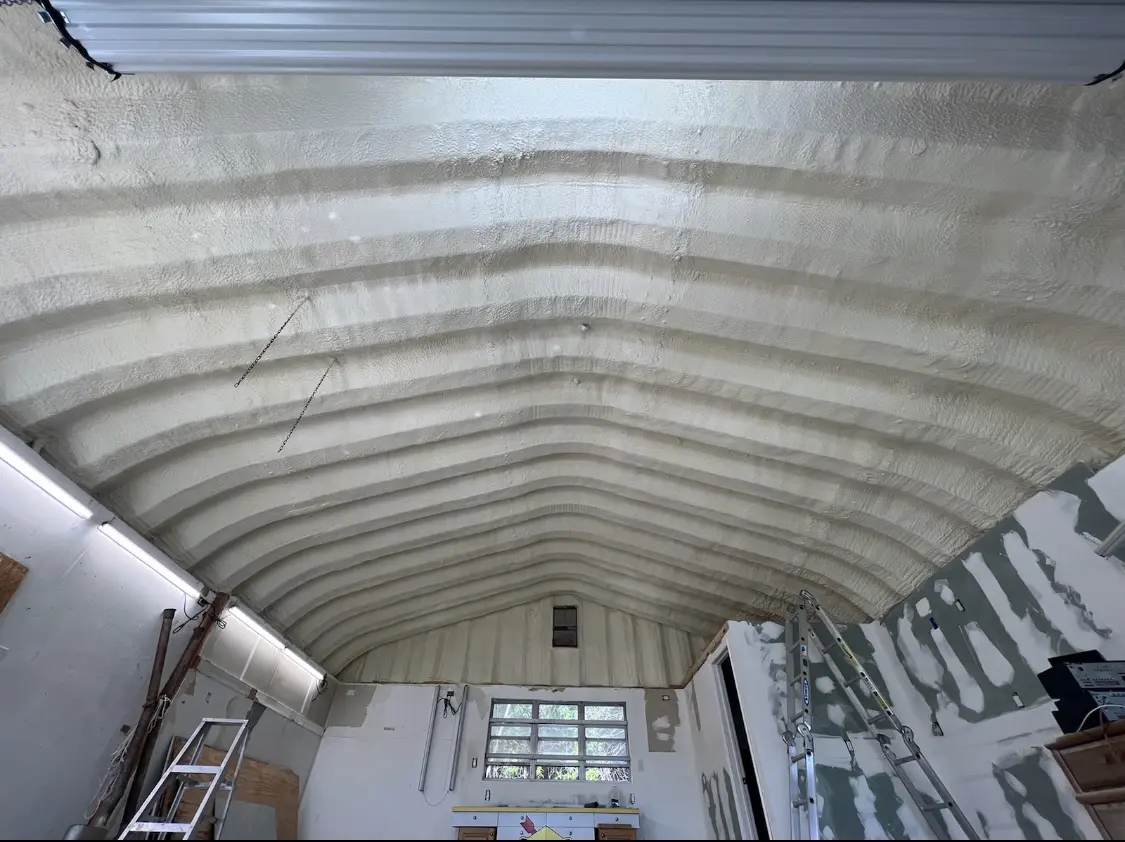 Spray polyurethane foam applied to the underside of a metal roof deck in Otsego